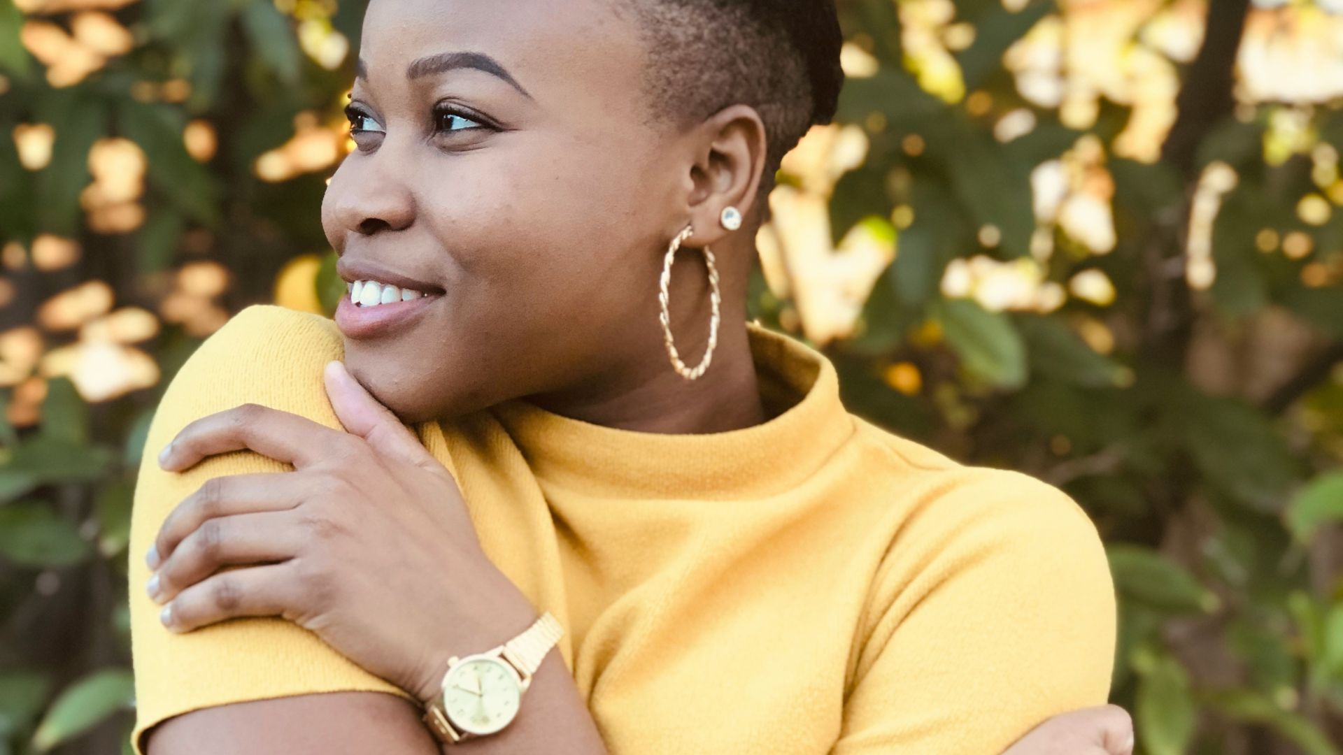 woman in yellow shirt holding yellow fruit