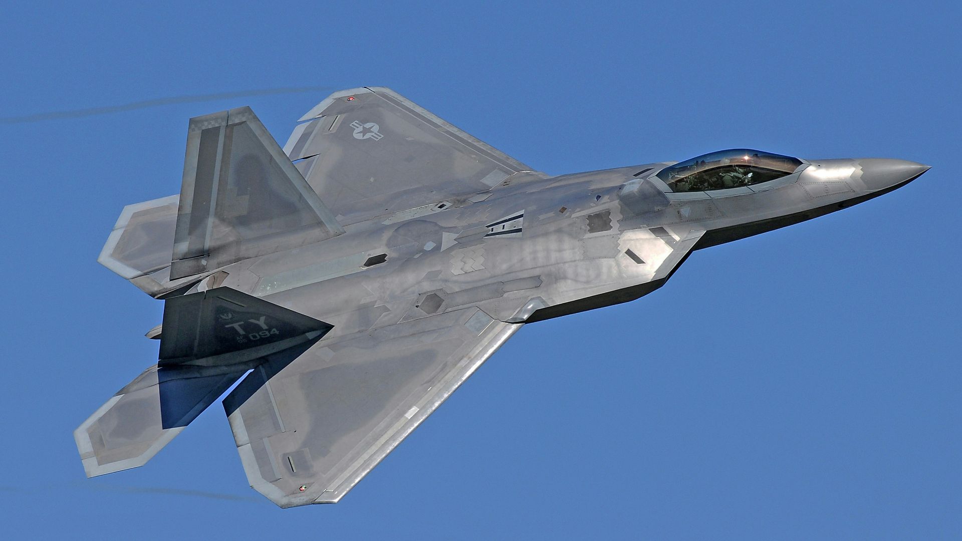 flying gray jet plane