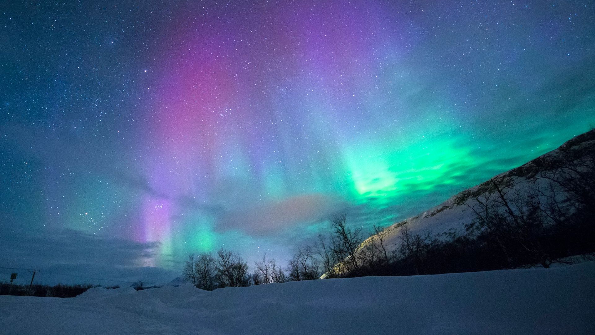 northern lights over snow-capped mountian