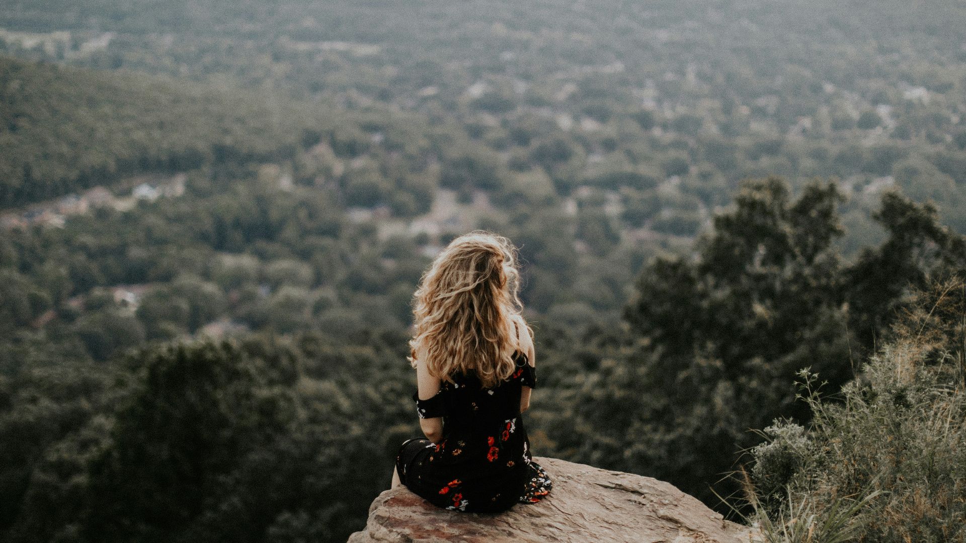 woman siting on cliff