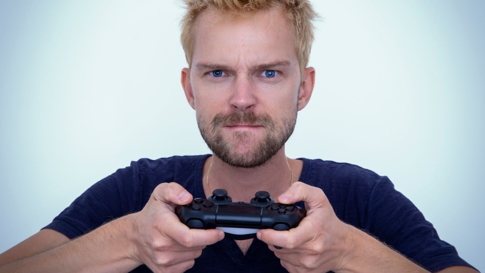 man in blue long sleeve shirt holding black semi automatic pistol