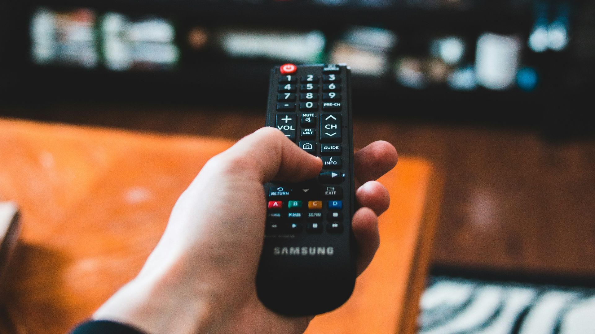 person holding black remote control