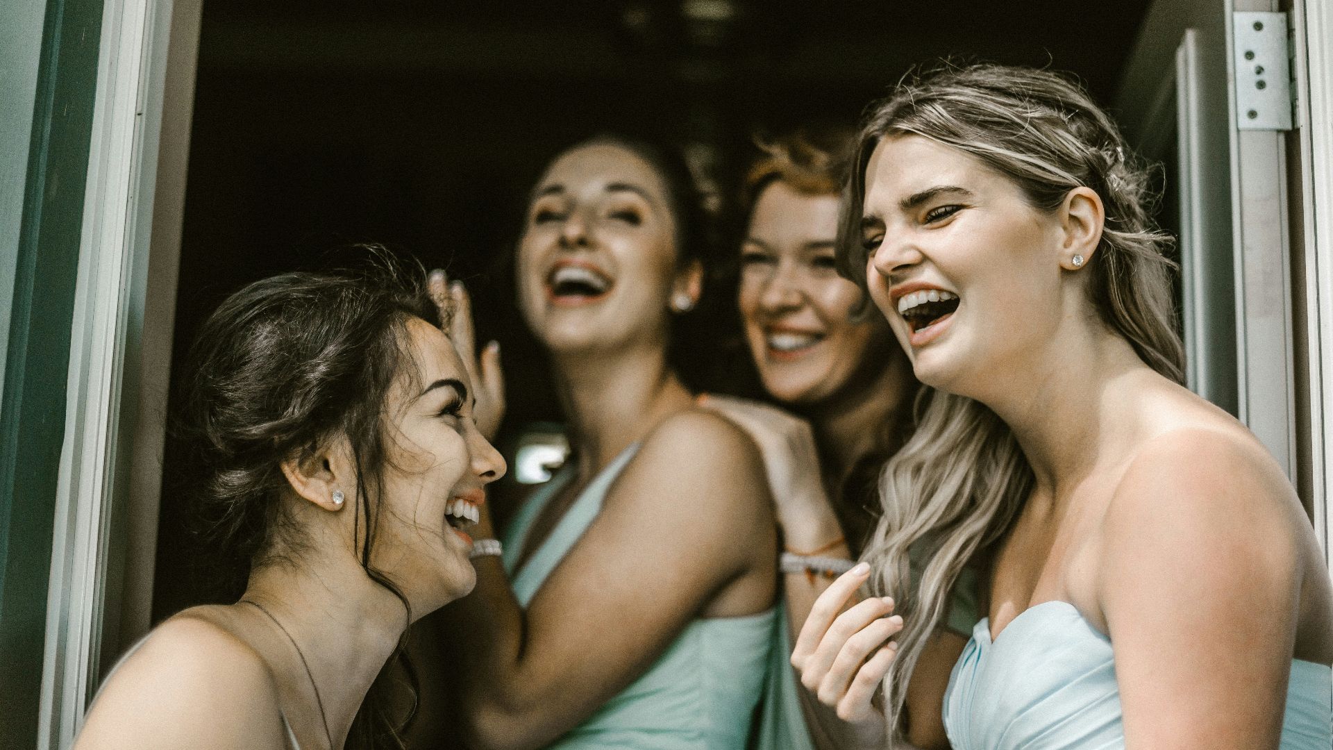 woman wearing teal tube dress while smiling