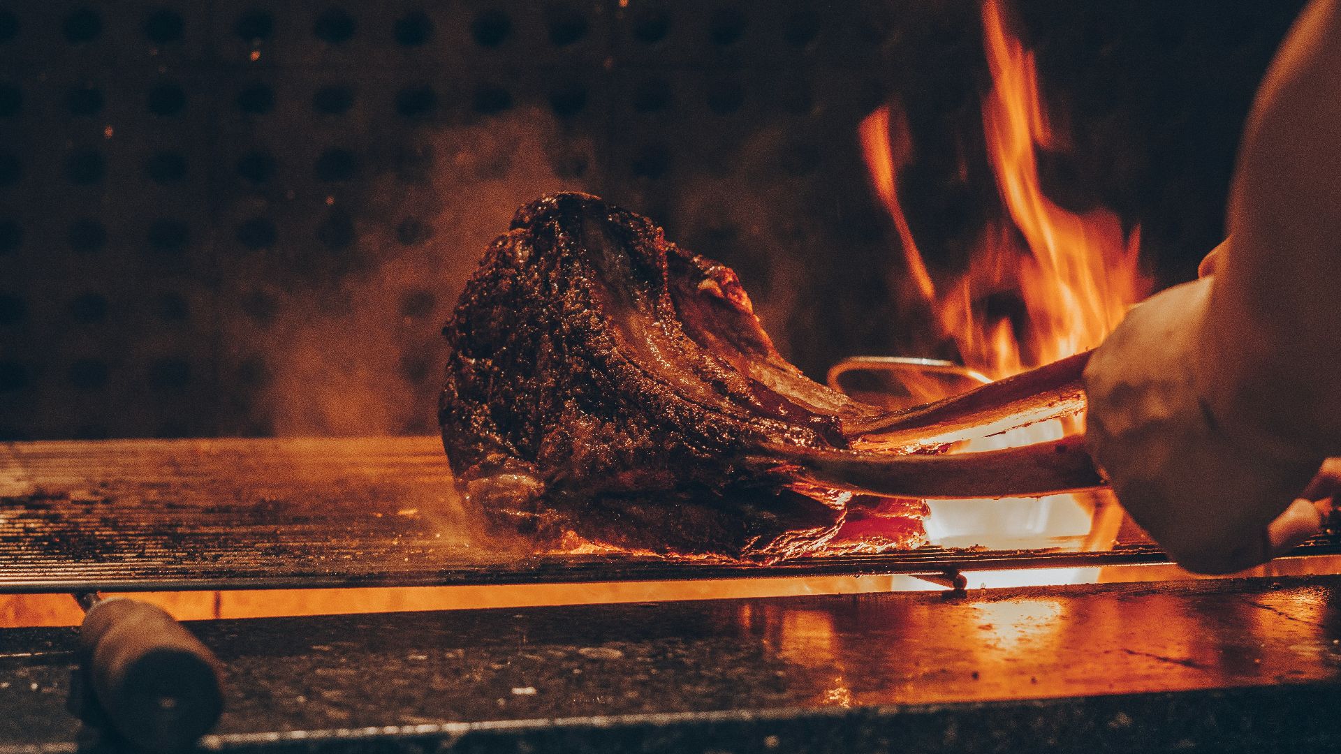 person barbecuing meat