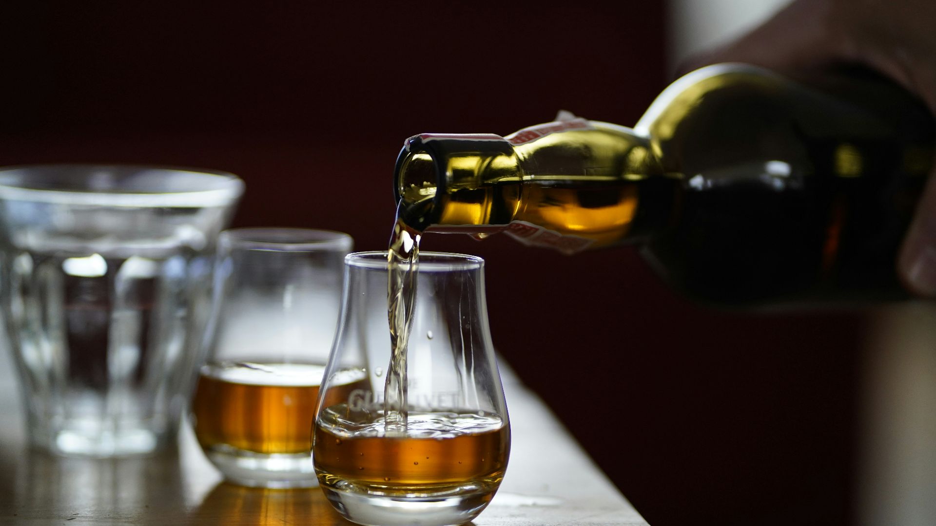 photo of person holding glass bottle