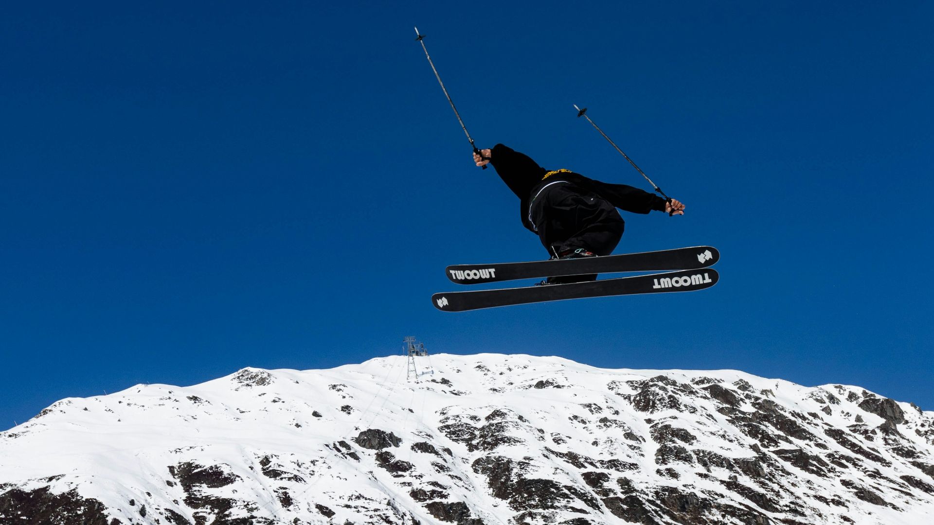 a man flying through the air while riding skis