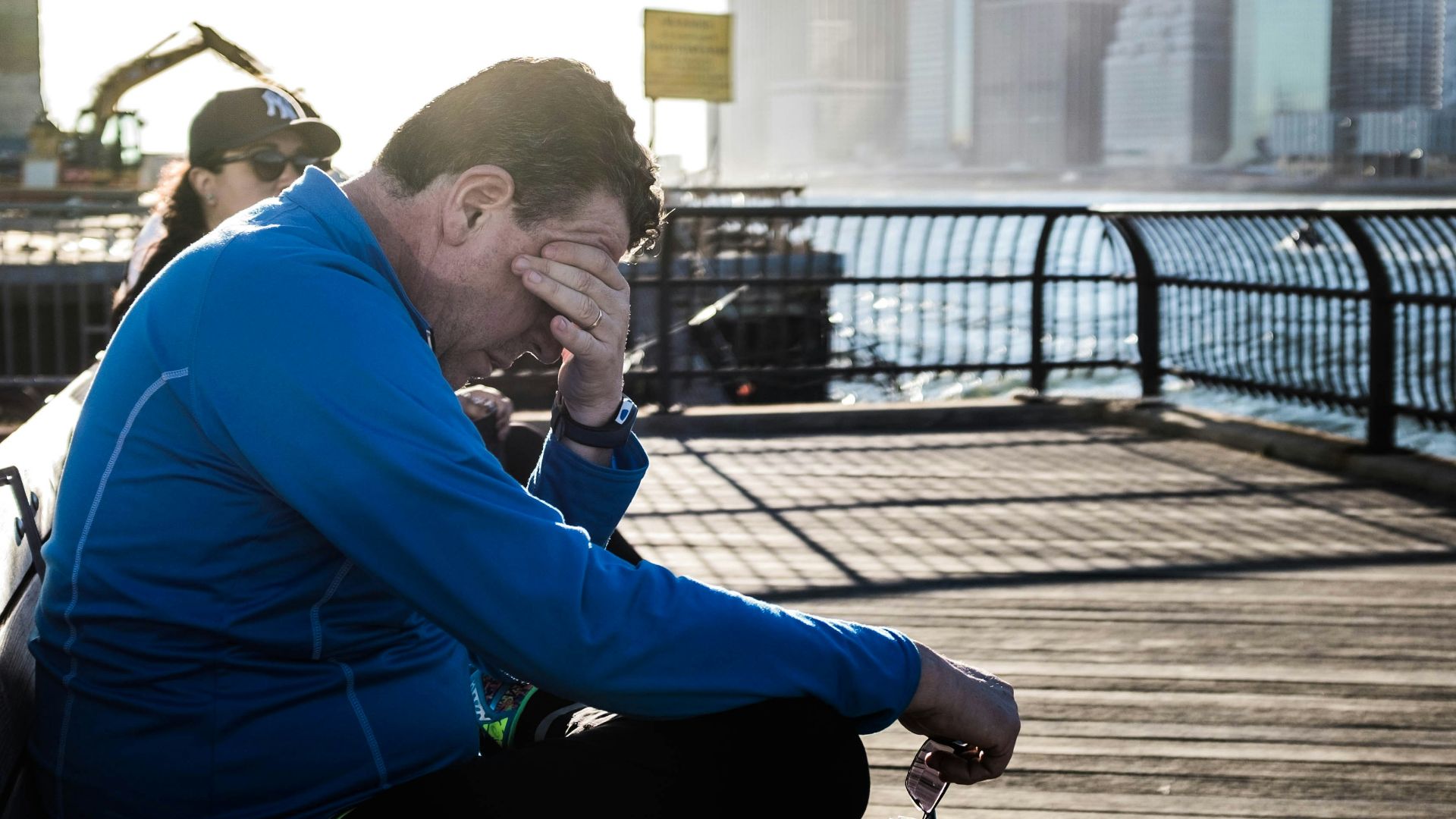 man sitting on bench beside woman