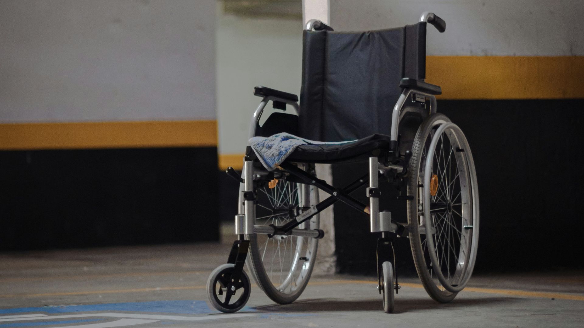 black and gray wheelchair on blue floor