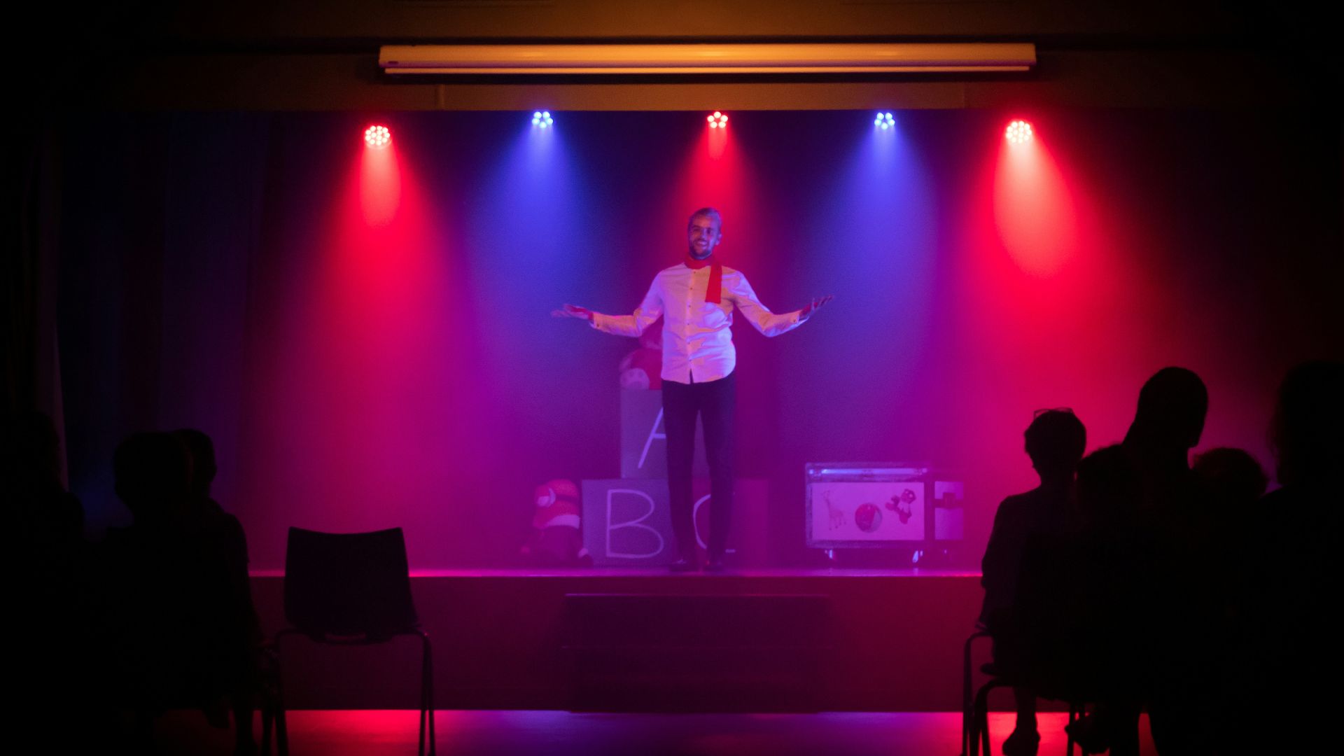 man in black shirt singing on stage