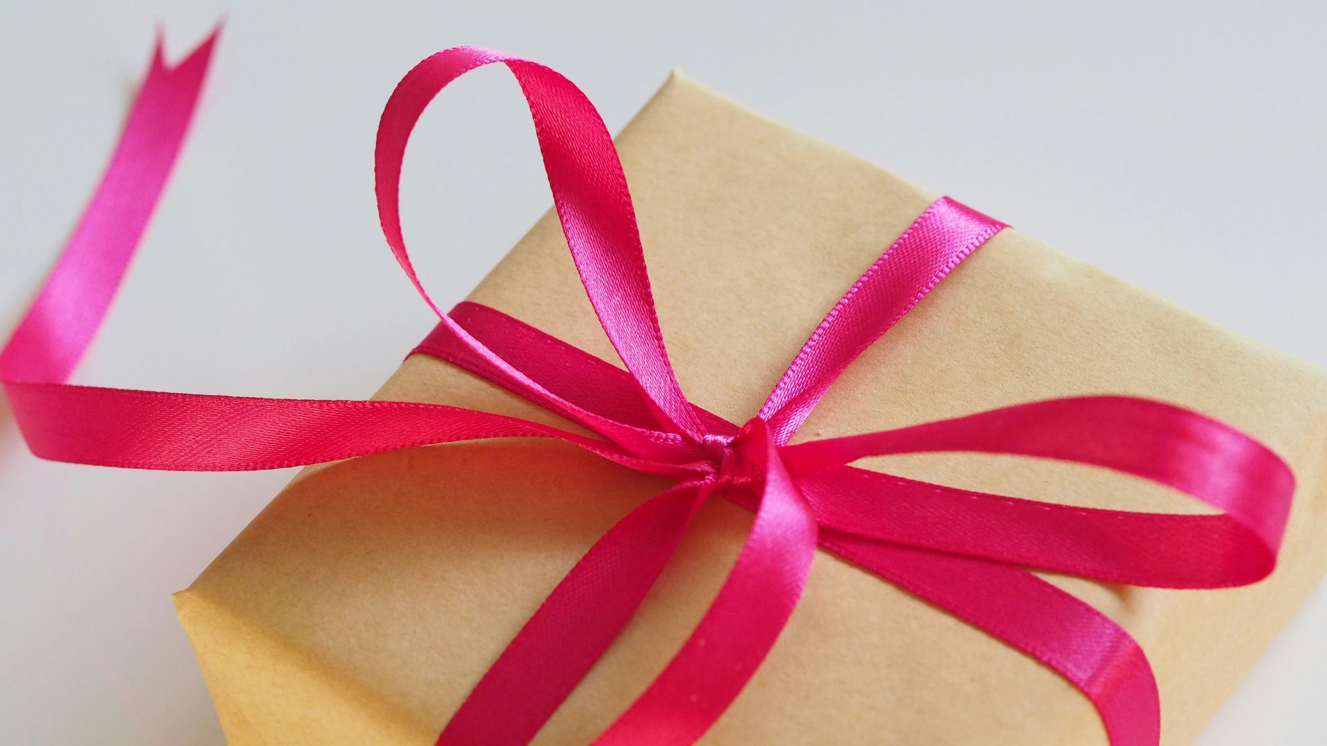 brown gift box with pink ribbon