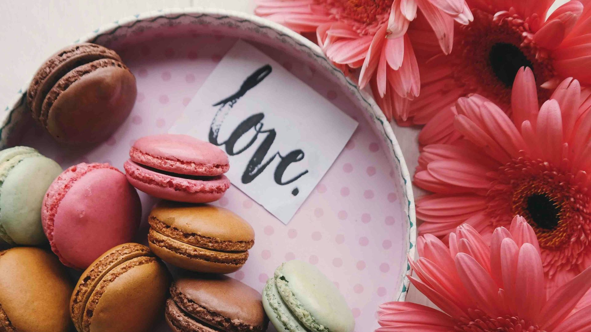 macaroons on a tray with the word 'love'