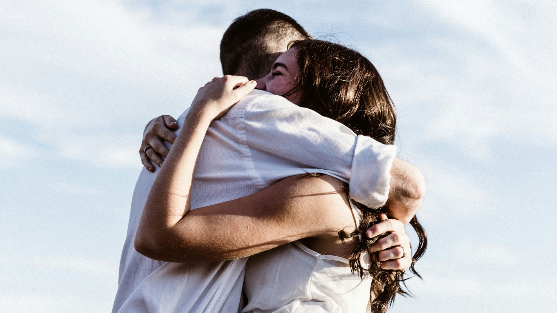 man and woman hugging each other photography