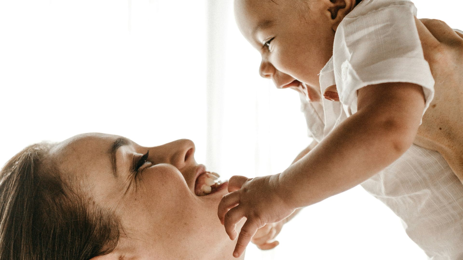 woman holding baby up