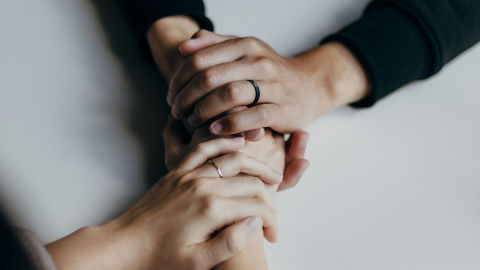 person in black long sleeve shirt holding babys feet