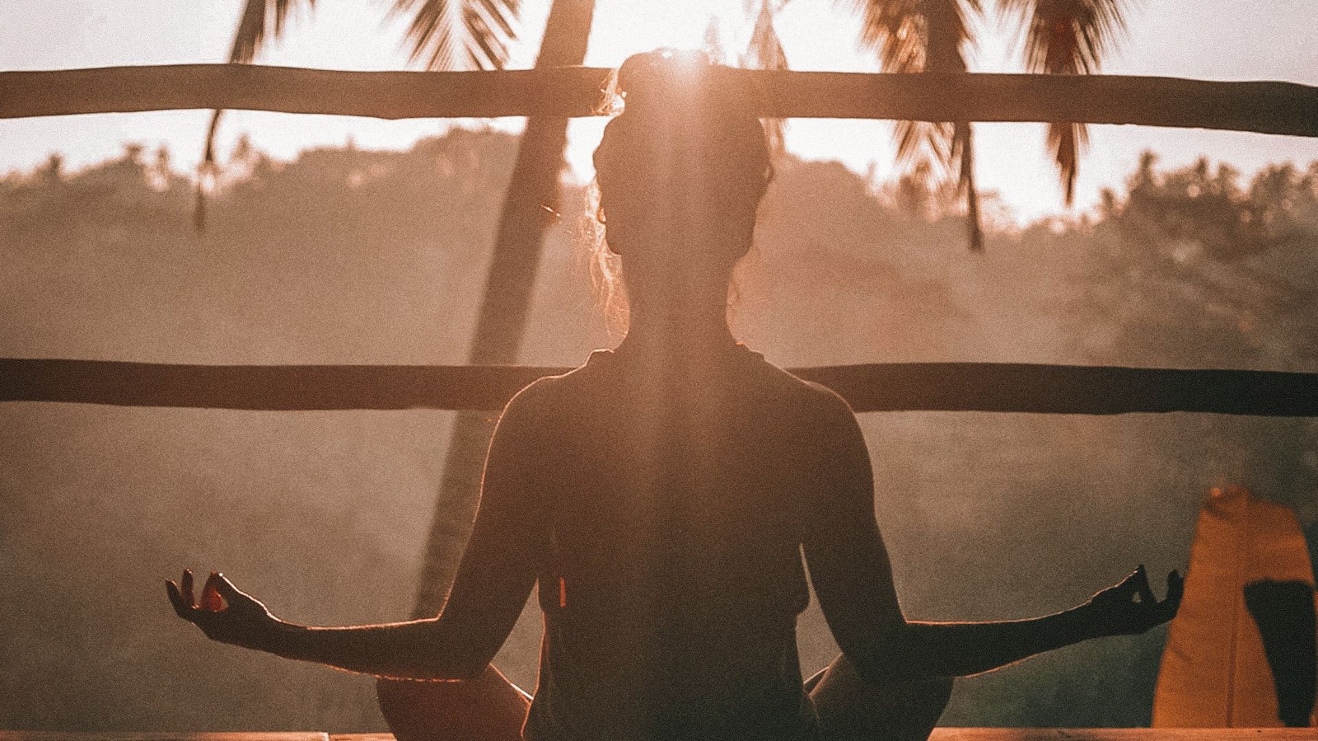woman doing yoga meditation on brown parquet flooring