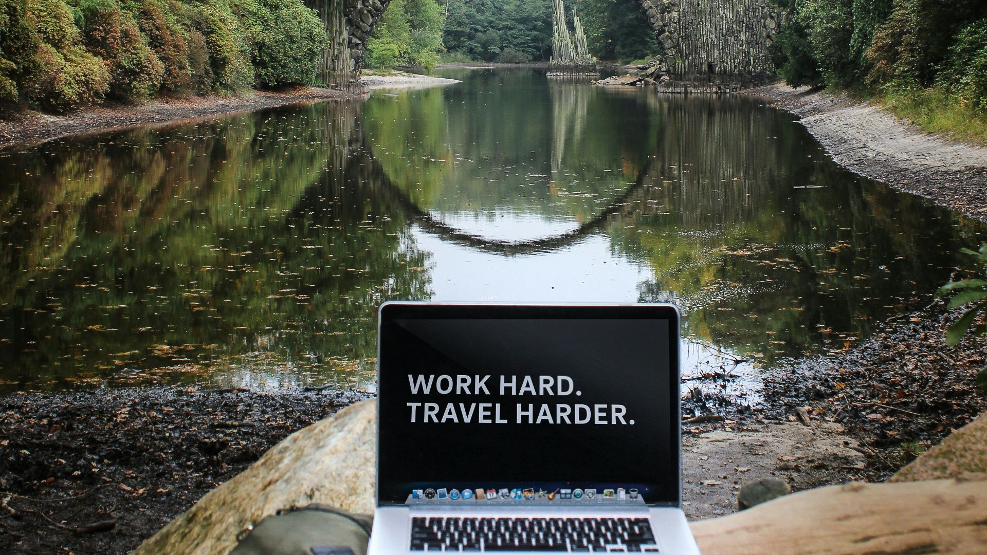 silver MacBook Pro on brown wood log