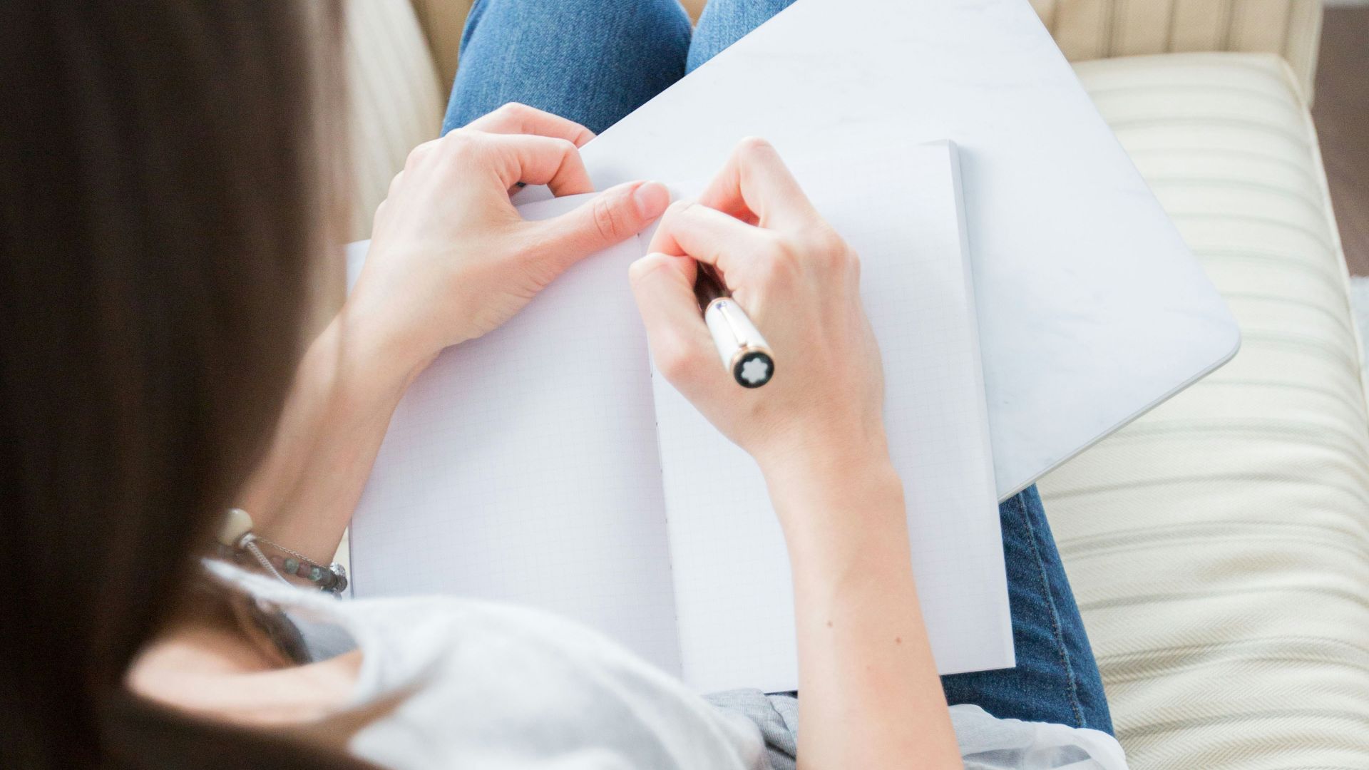 woman writing on white paper