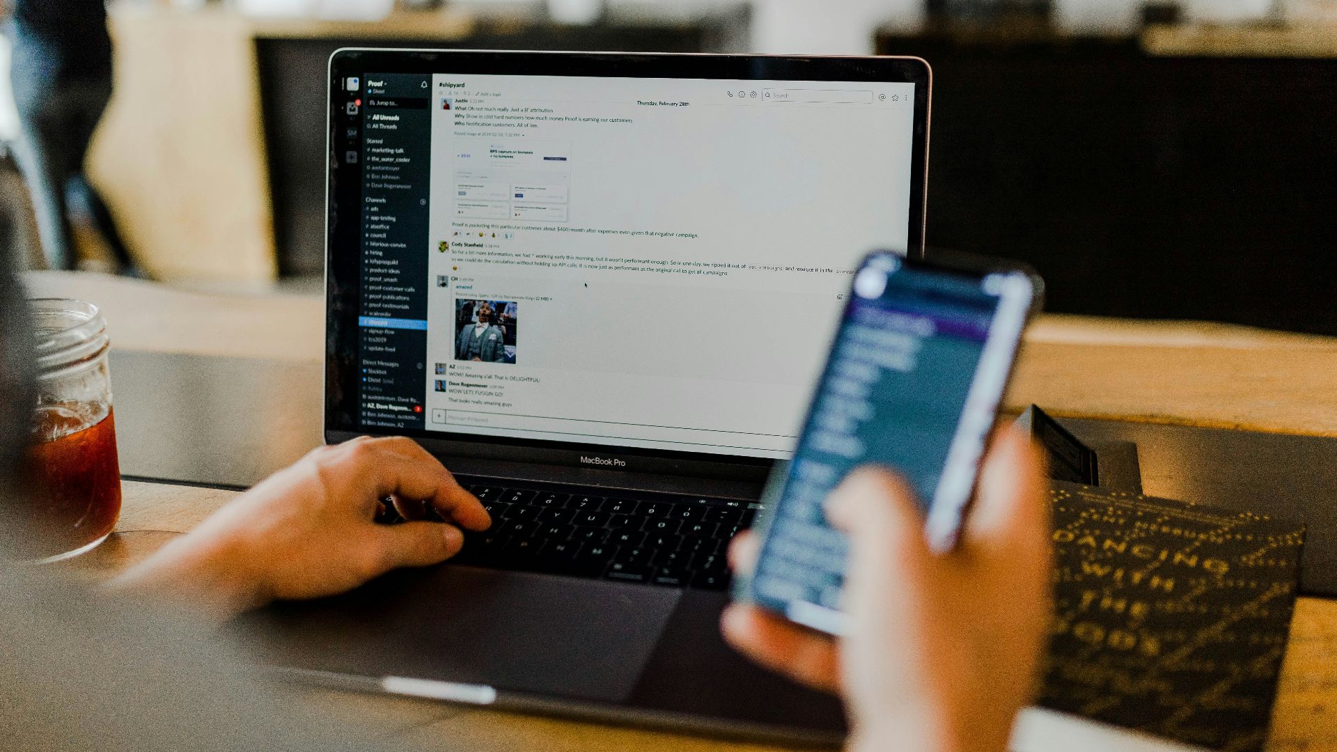 person using phone and laptop