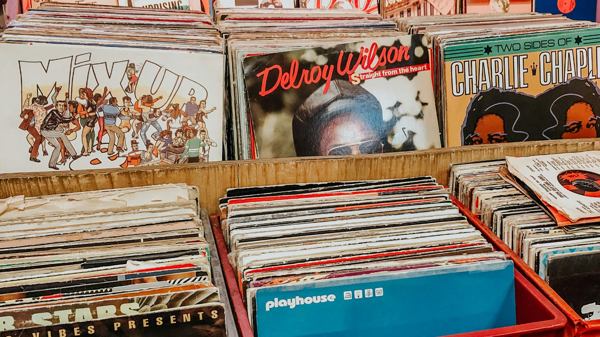 assorted books on red plastic crate