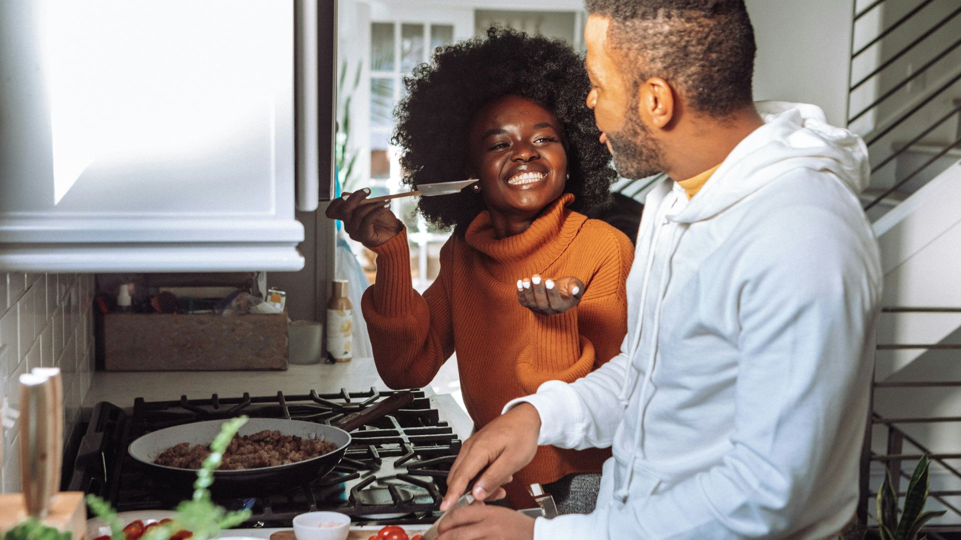 man in white dress shirt holding a woman in brown long sleeve shirt
