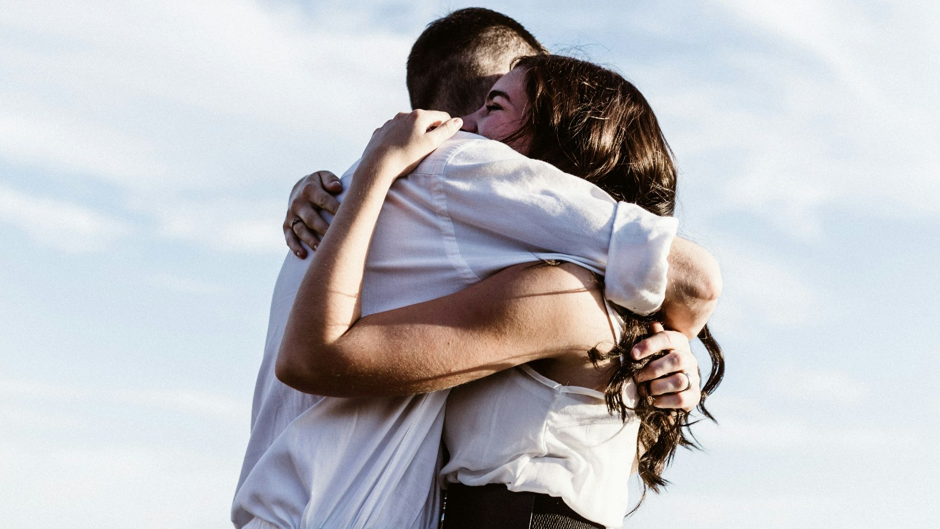 man and woman hugging each other photography