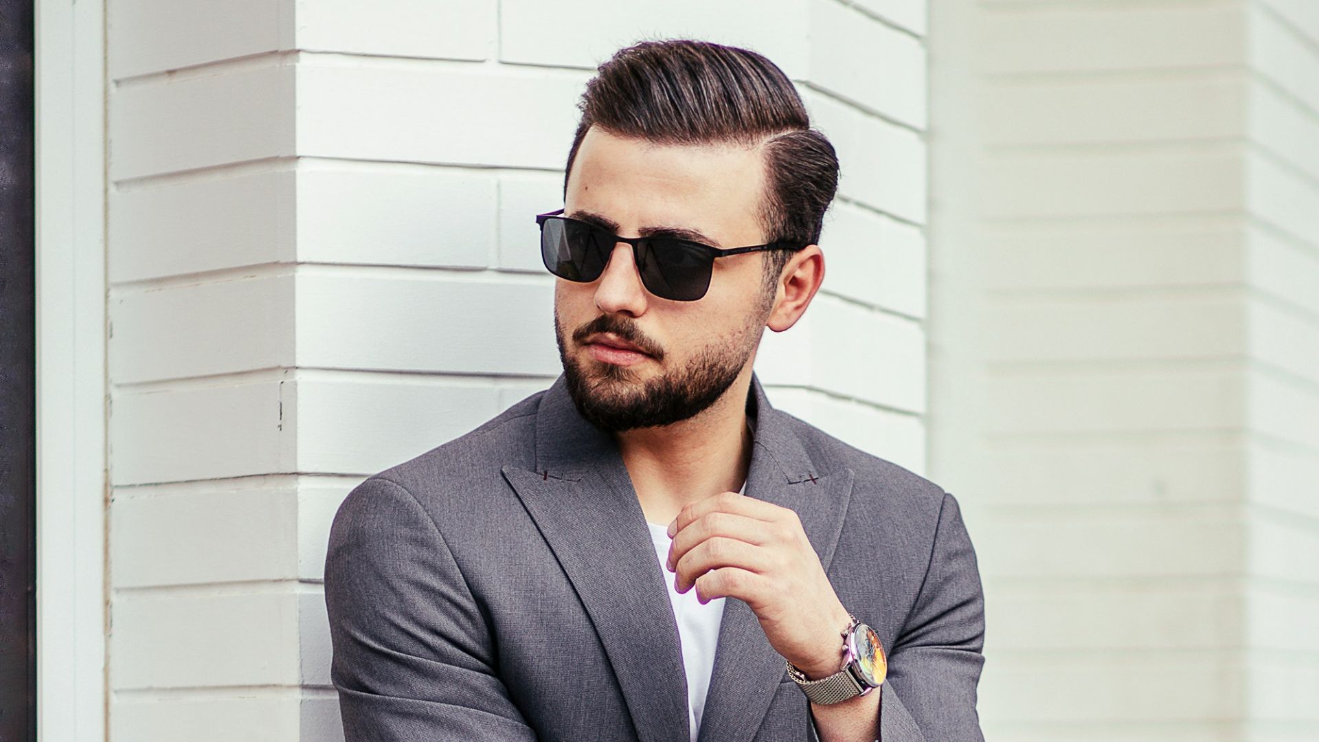 man in gray suit jacket wearing black sunglasses