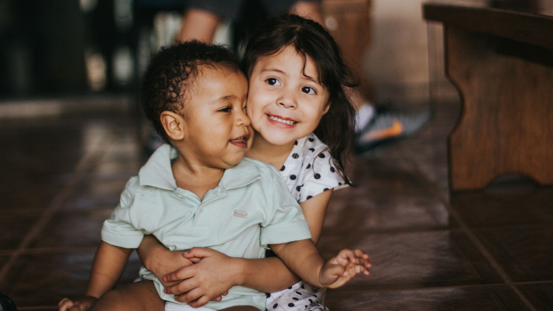 selective focus photography of girl hugging boy