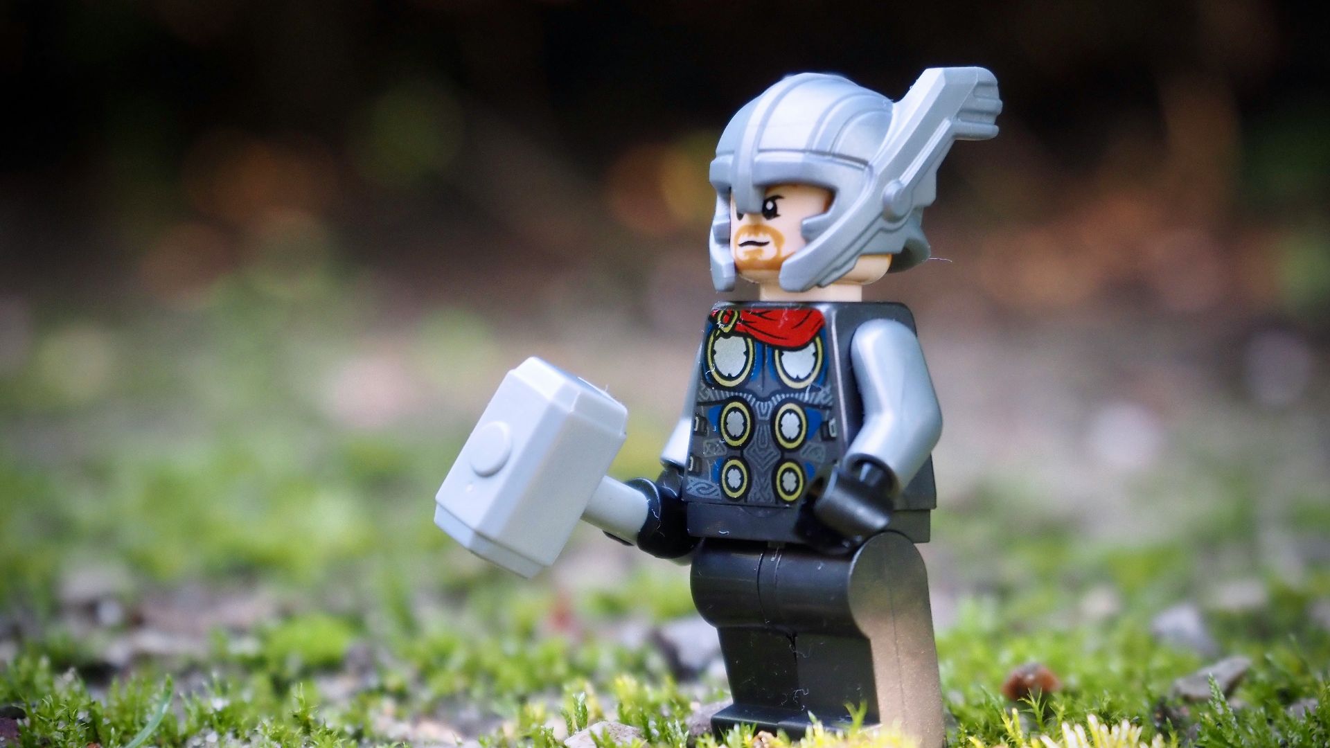 lego minifig on green grass during daytime