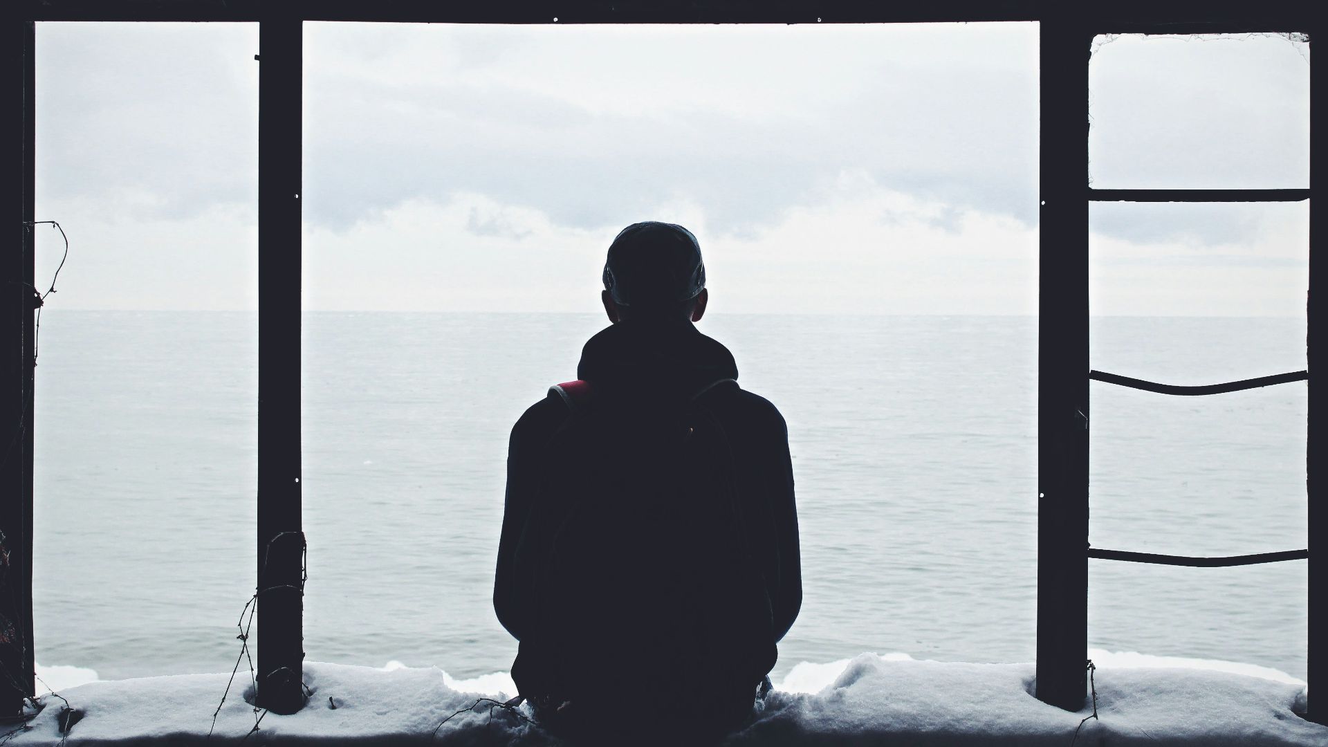 person looking out through window