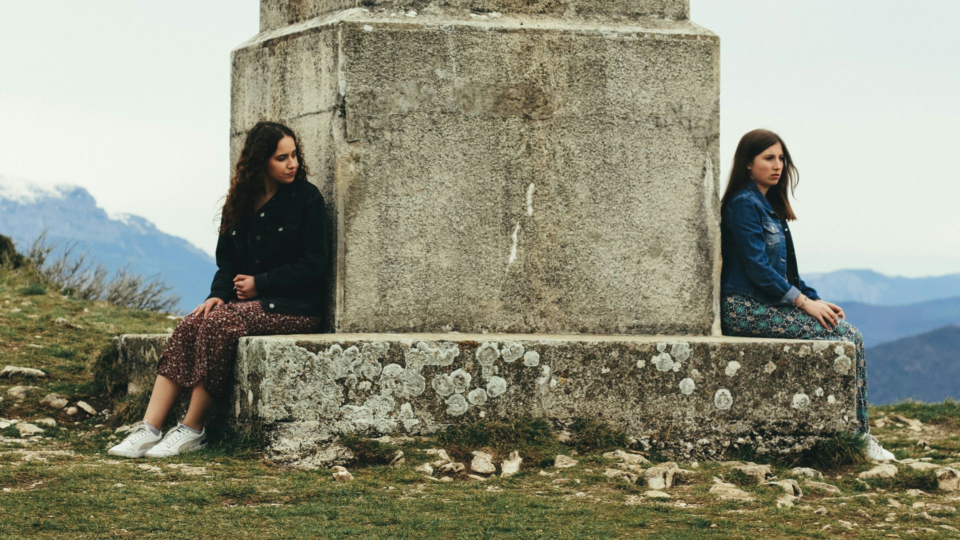 woman in black jacket sitting beside woman in black jacket