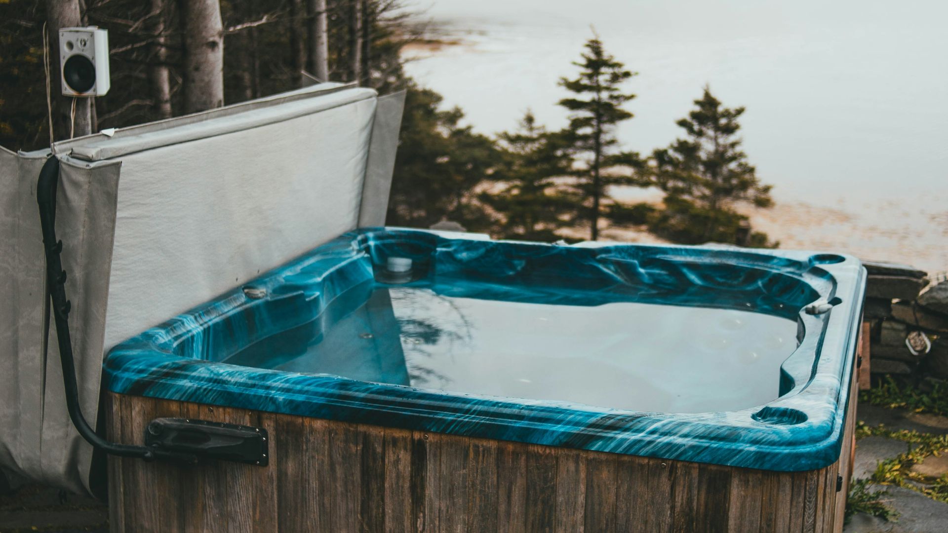 a hot tub sitting next to a body of water