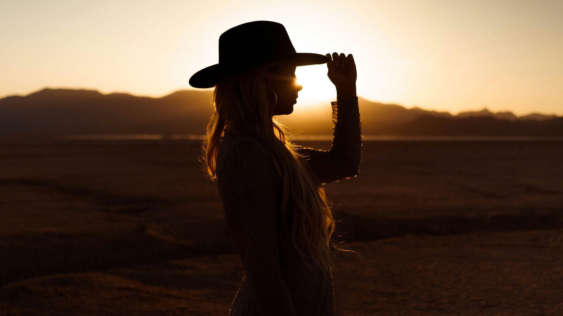 woman in white dress wearing black fedora hat