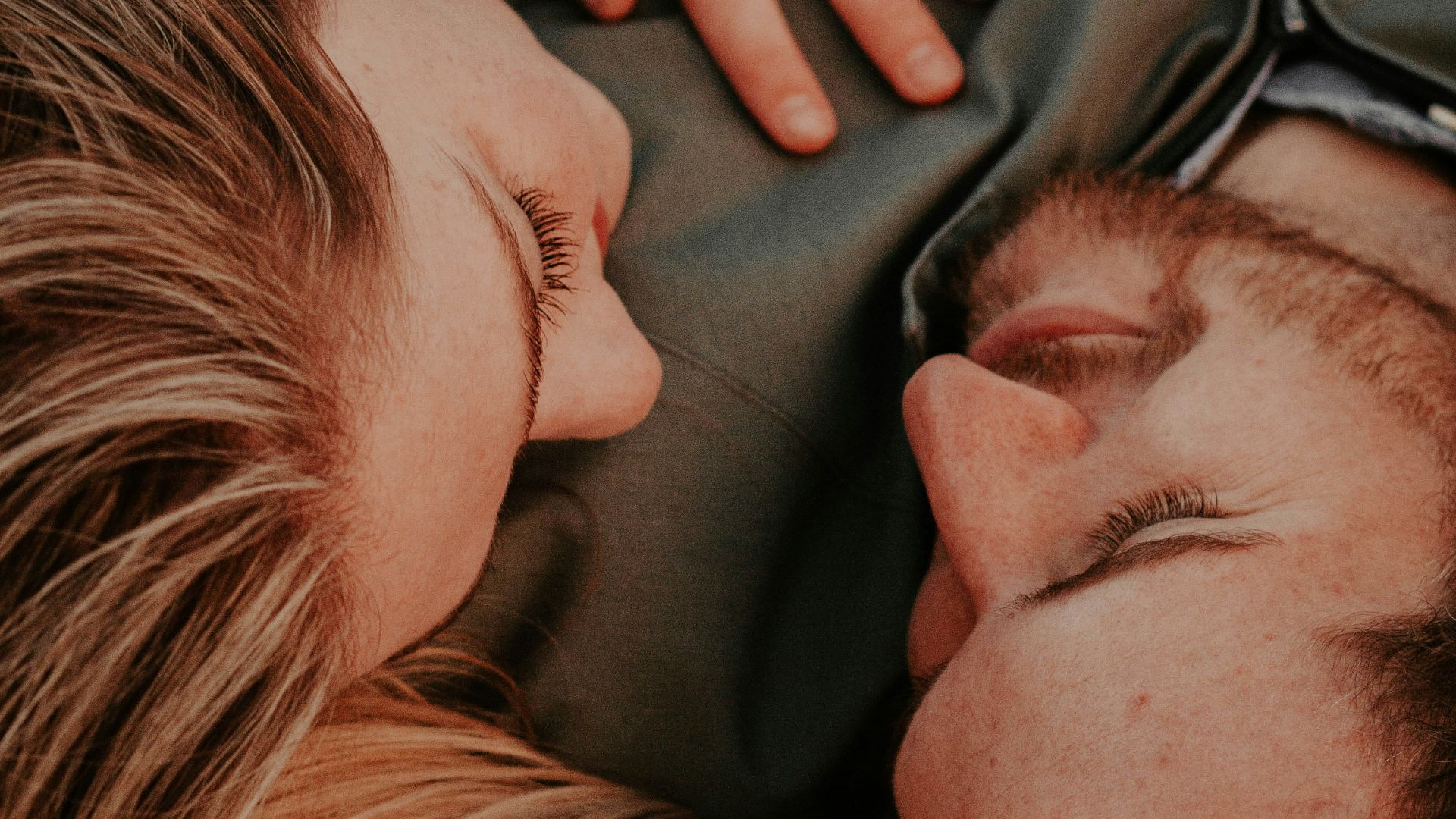 a woman stares into a man's eyes lovingly