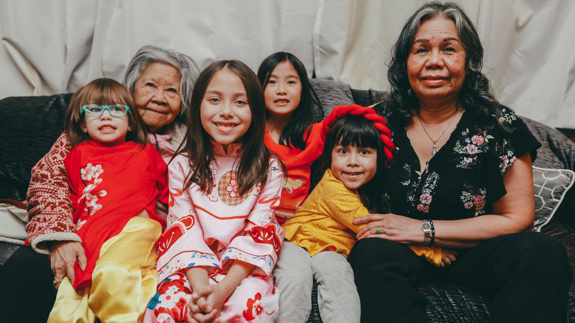 a group of women sitting next to each other on a couch