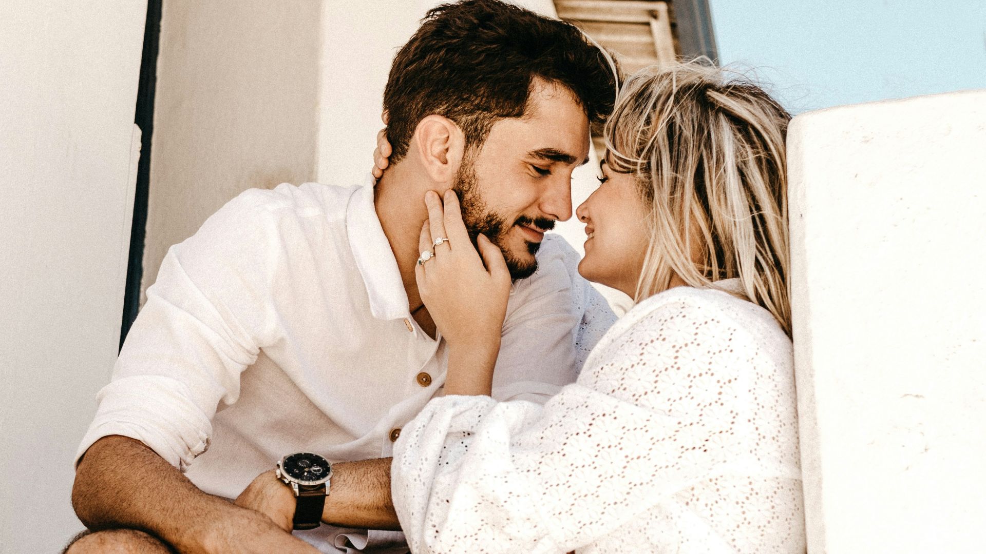 smiling man and woman about to kiss