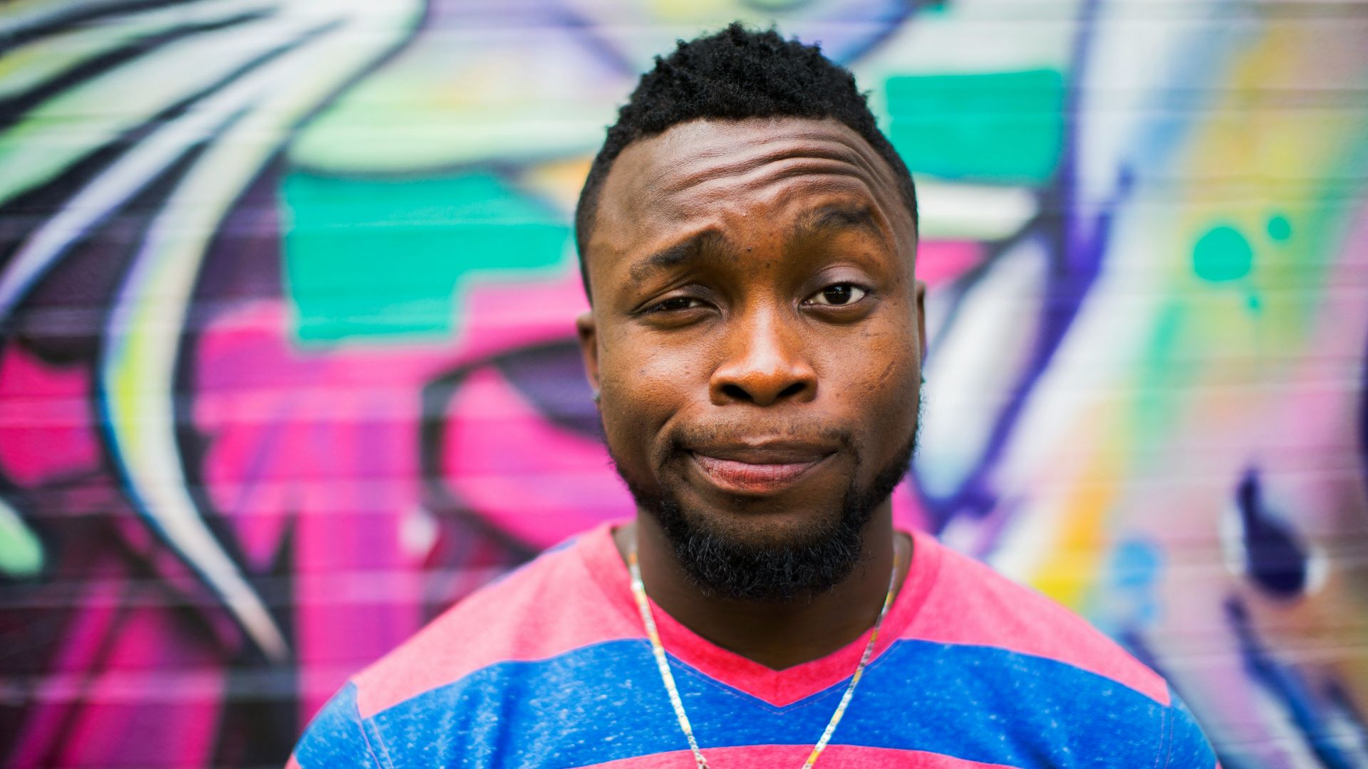 black haired man making face