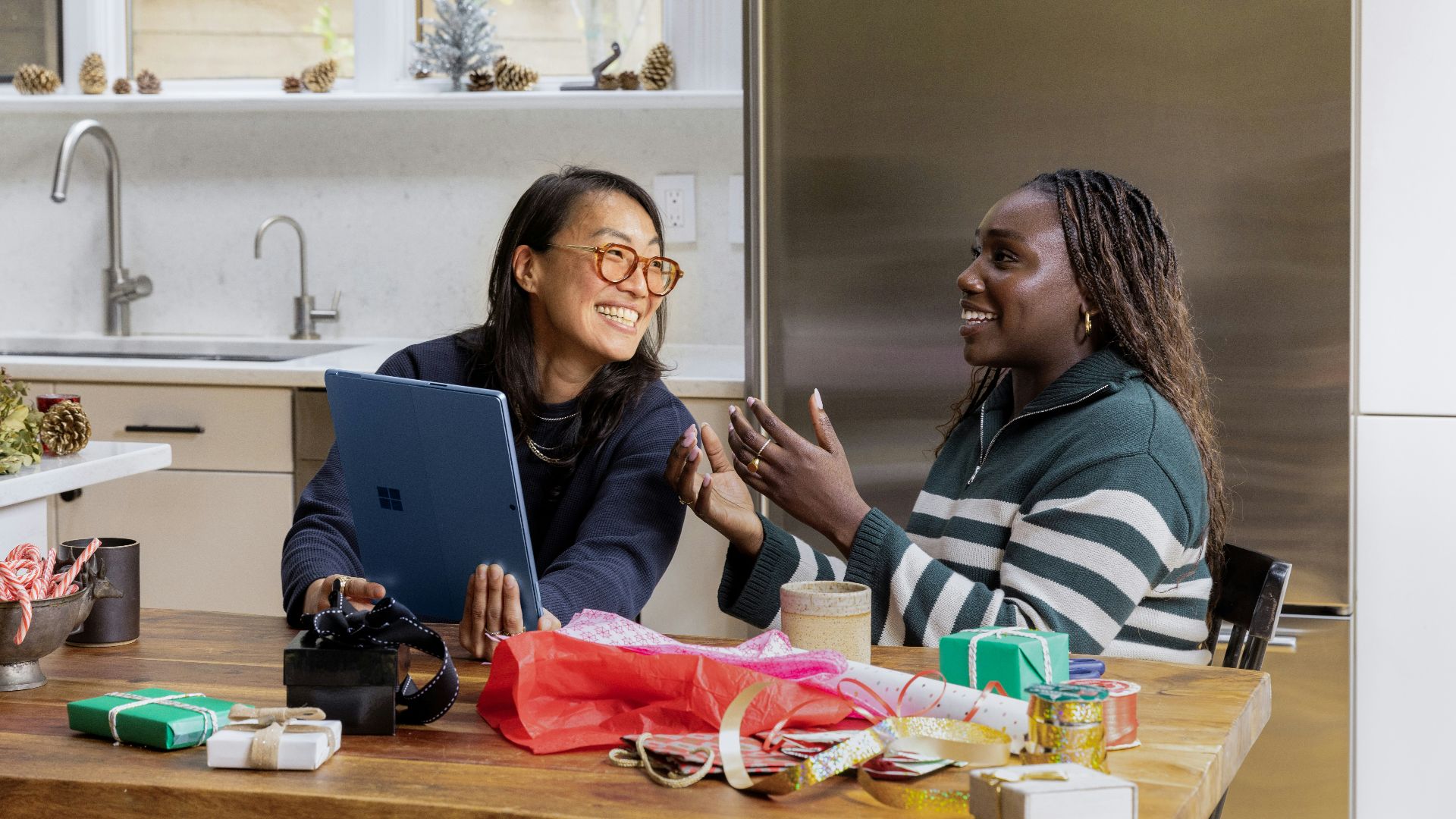 a woman sitting at a table in front of a window