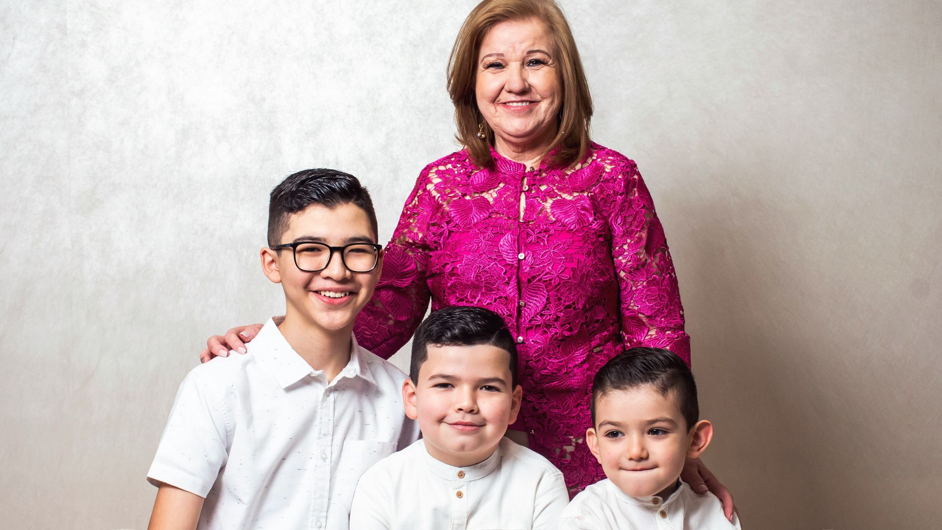 a woman and two boys are posing for a picture