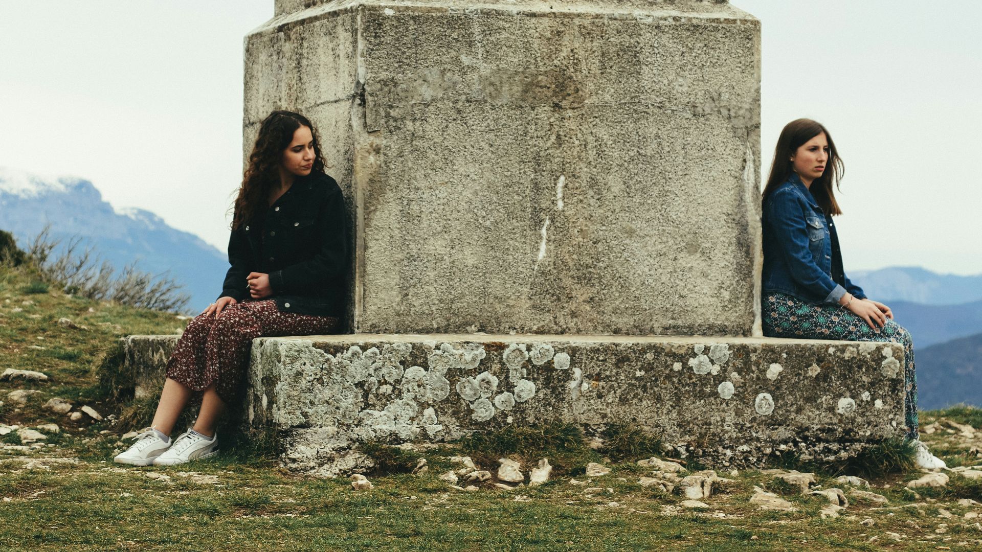woman in black jacket sitting beside woman in black jacket
