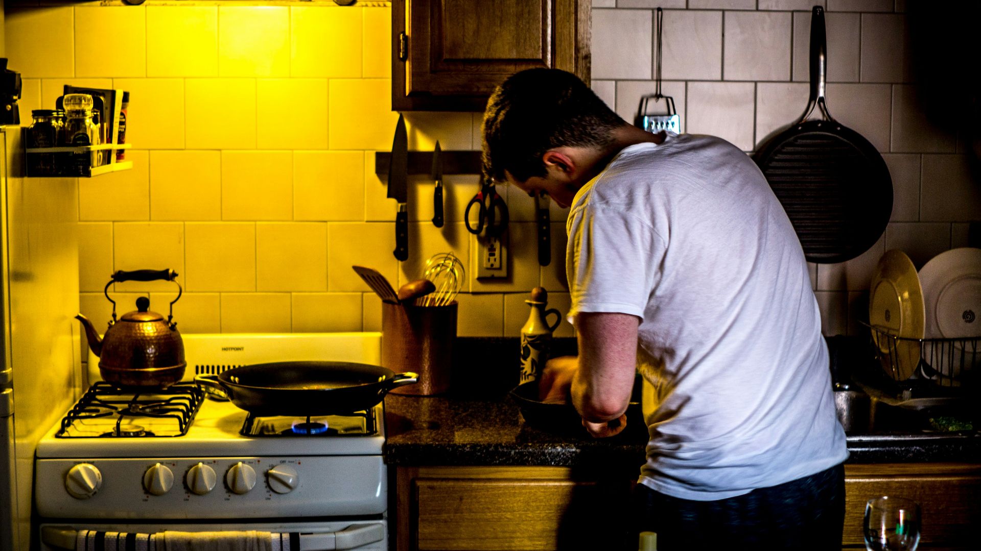 man standing beside range oven