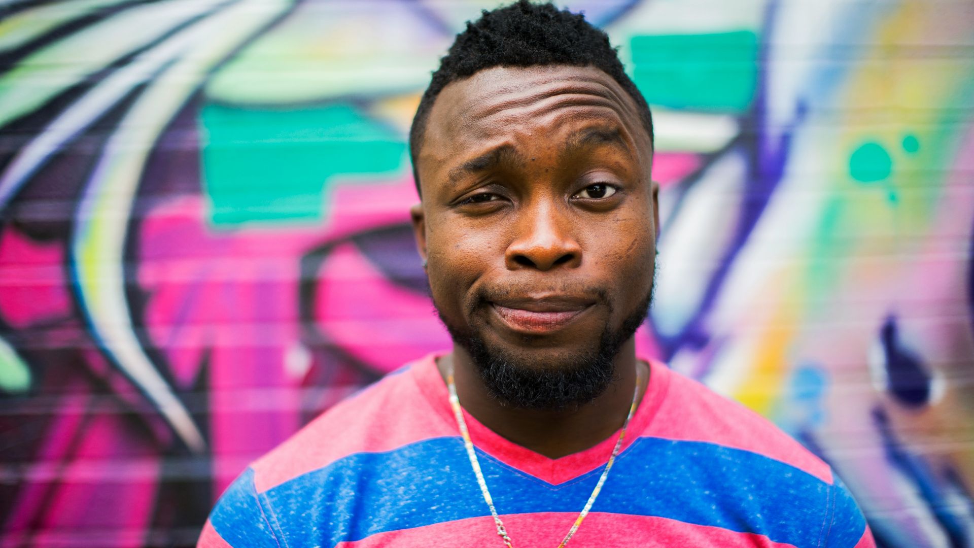 black haired man making face