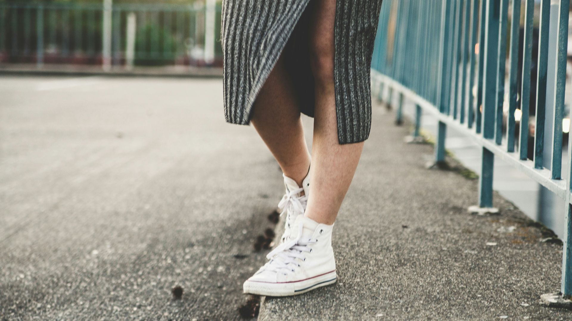 woman standing beside the fence
