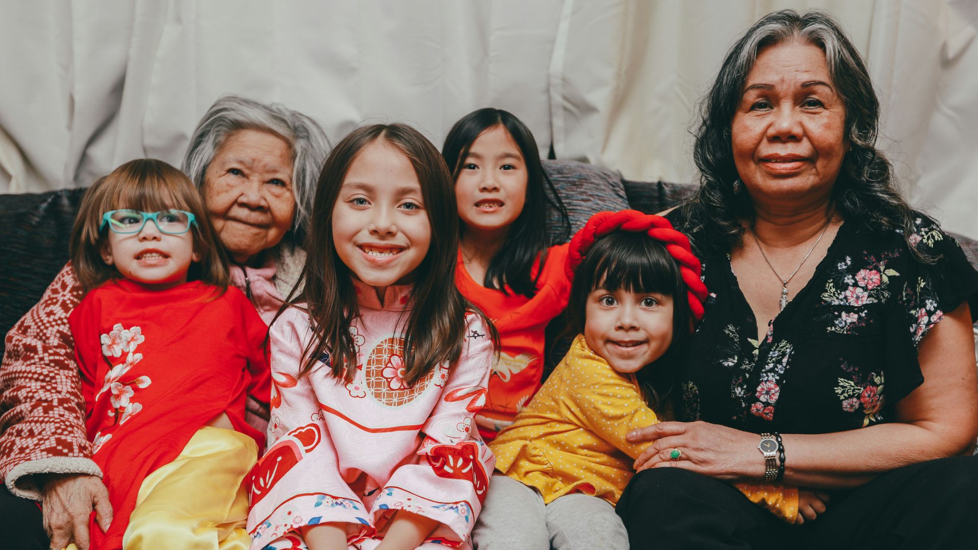 a group of women sitting next to each other on a couch