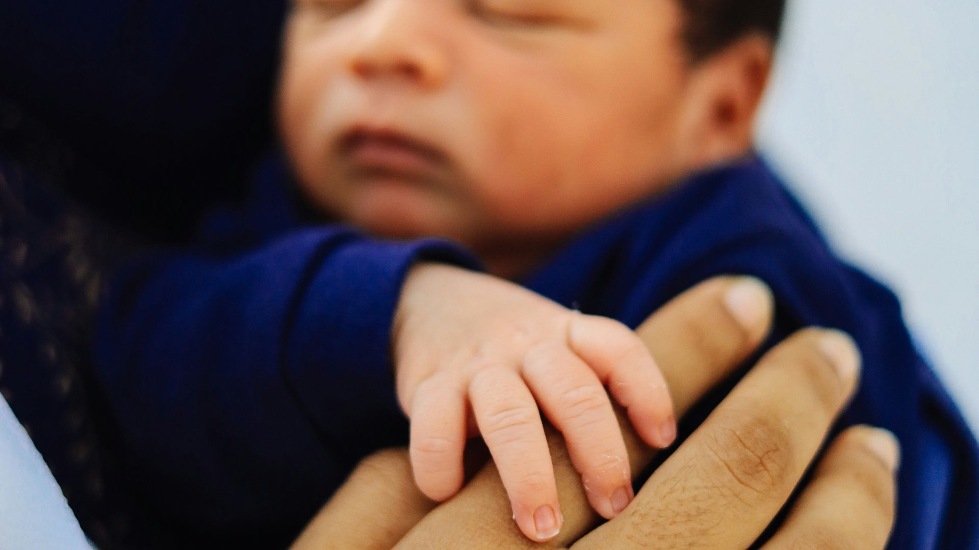 a woman holding a baby in her arms