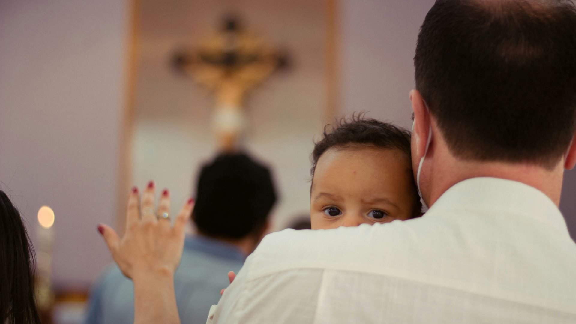 boy in white shirt raising his hands