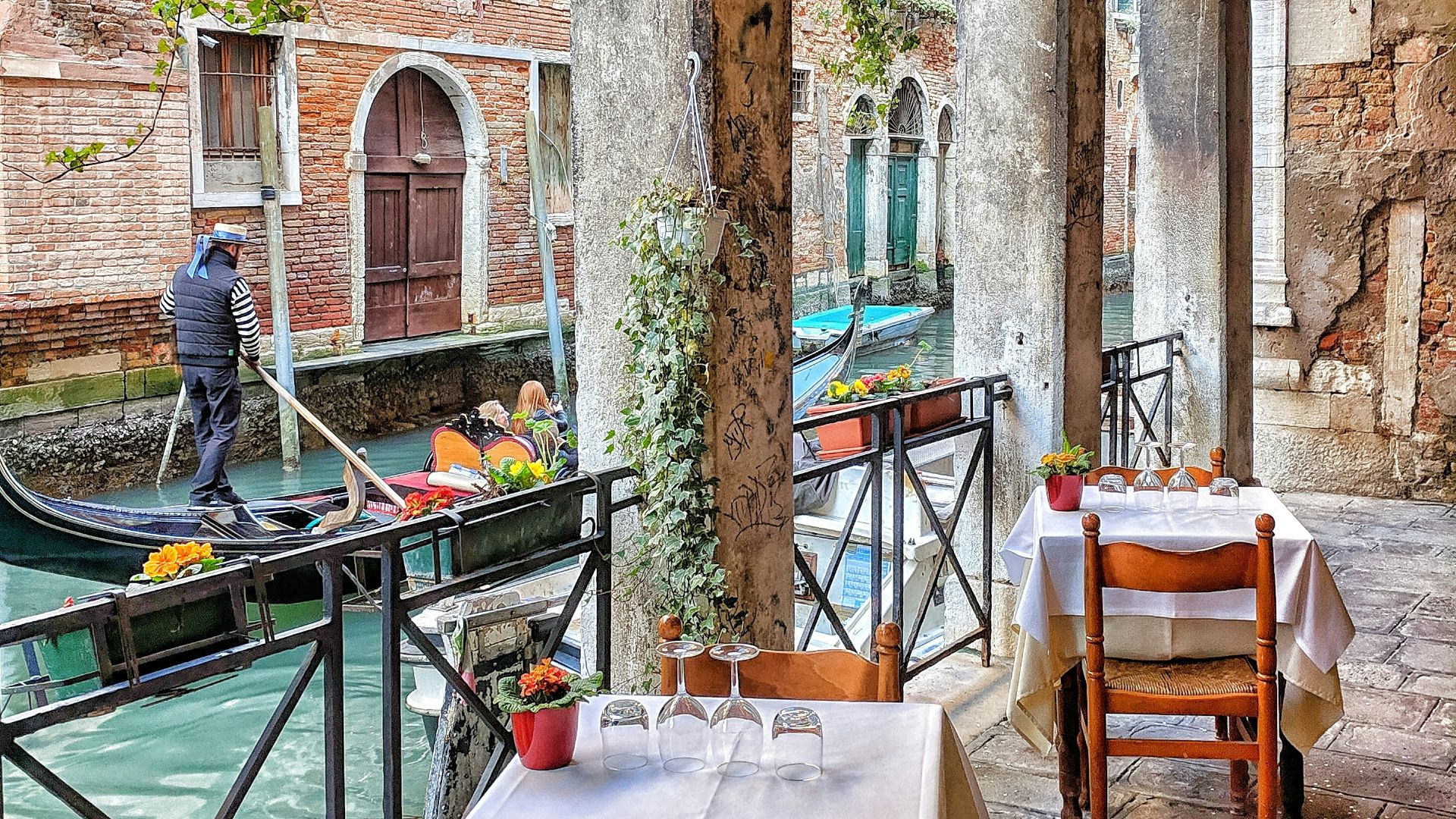 man riding on boat beside restaurant