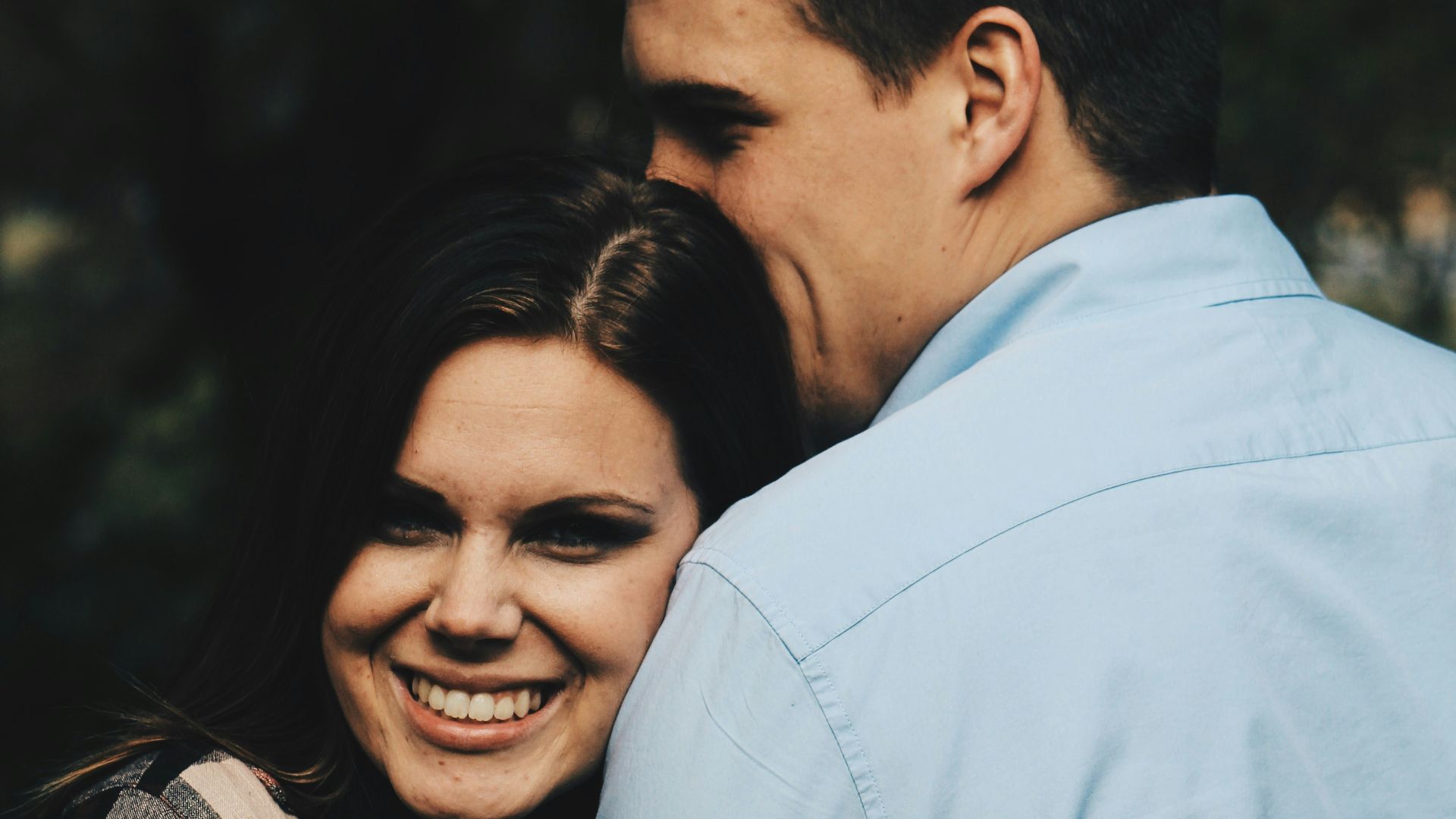 woman holding arms of man