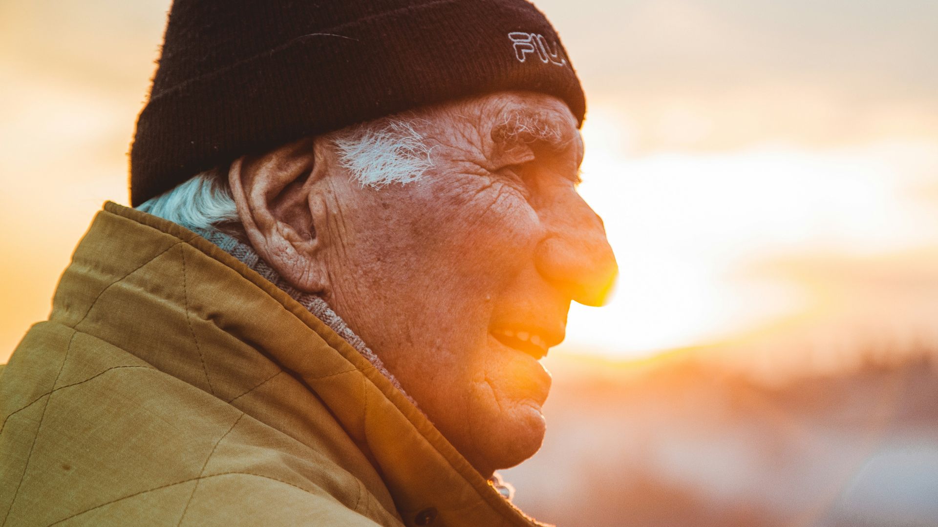 man wearing brown jacket and knit cap