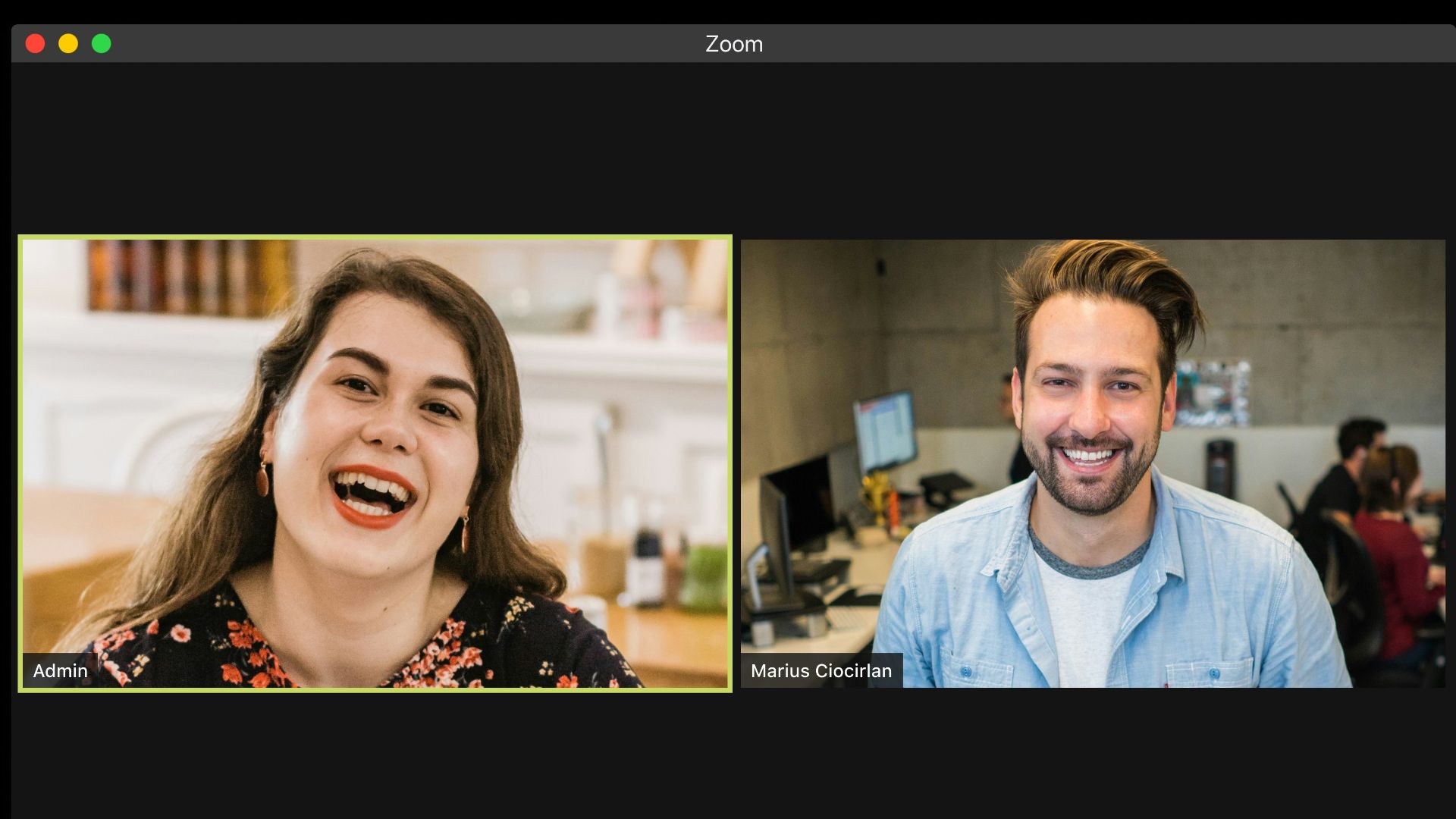 man in blue dress shirt smiling beside woman in black and red floral dress