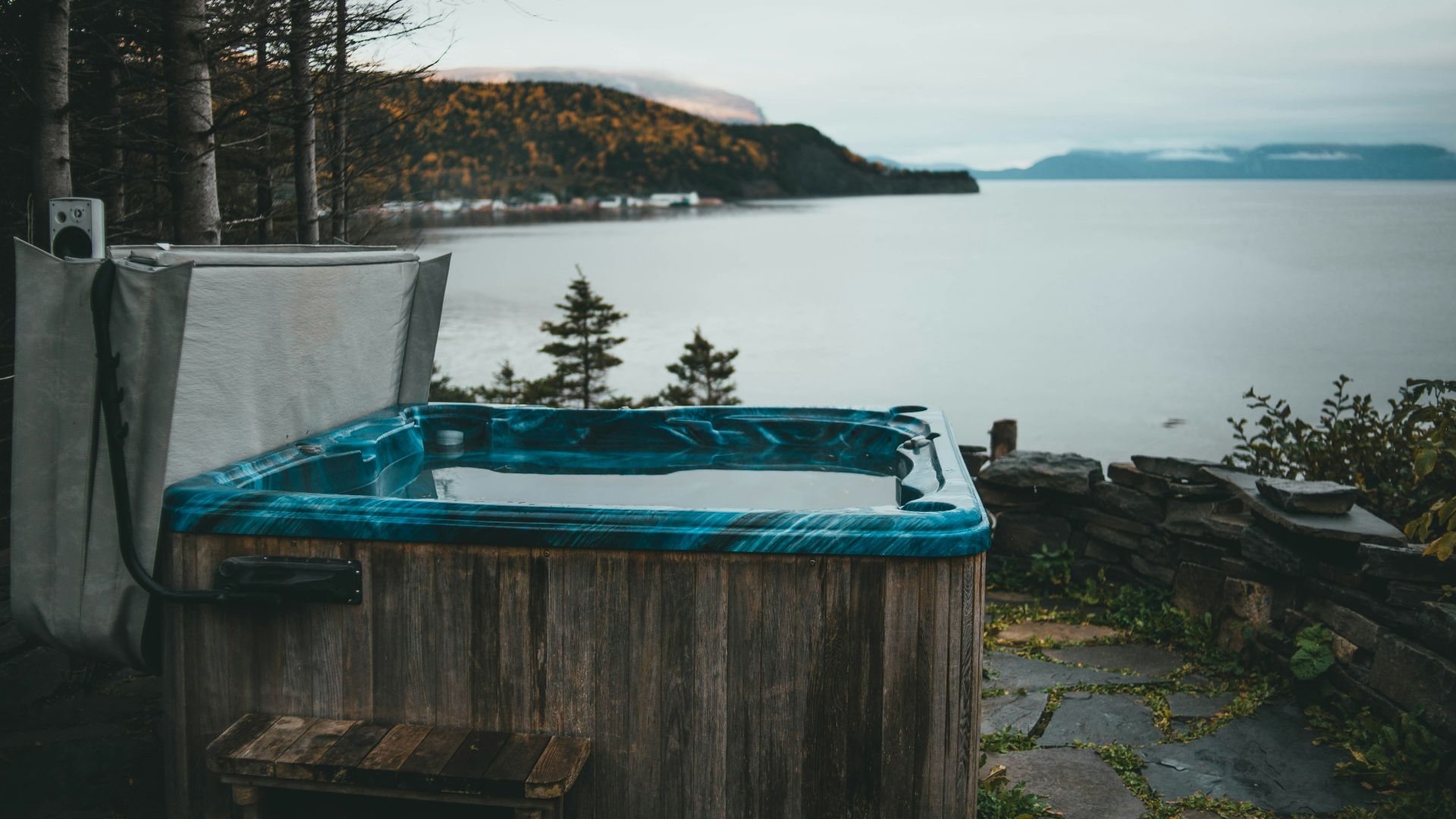 a hot tub sitting next to a body of water